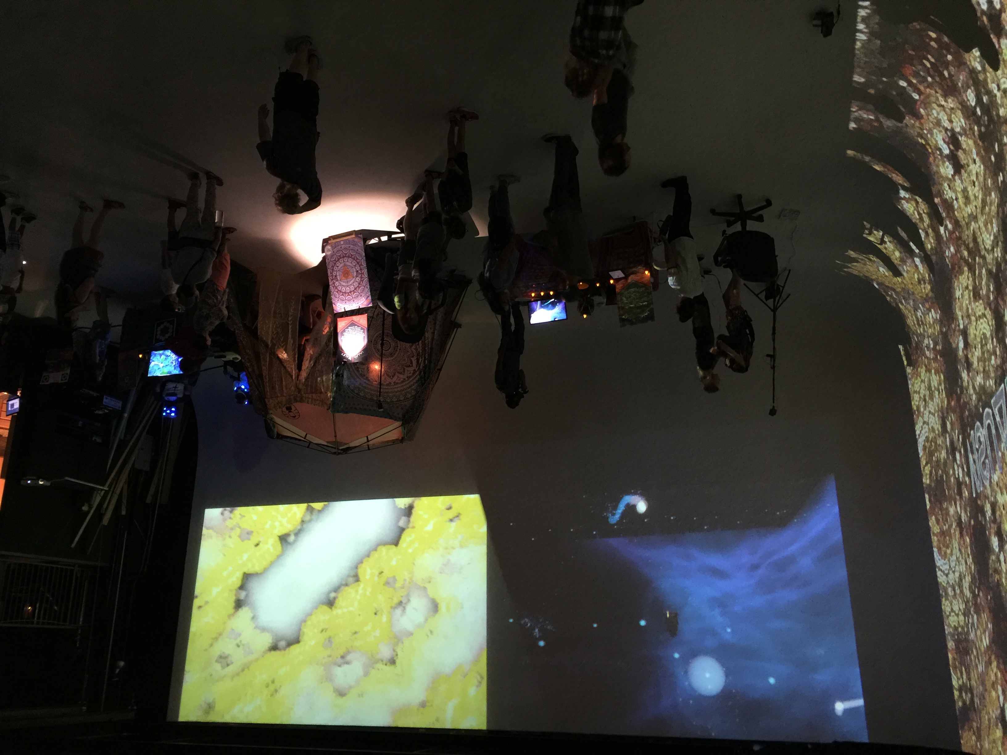 Overhead view of immersive event with projections, tent structure and visitors