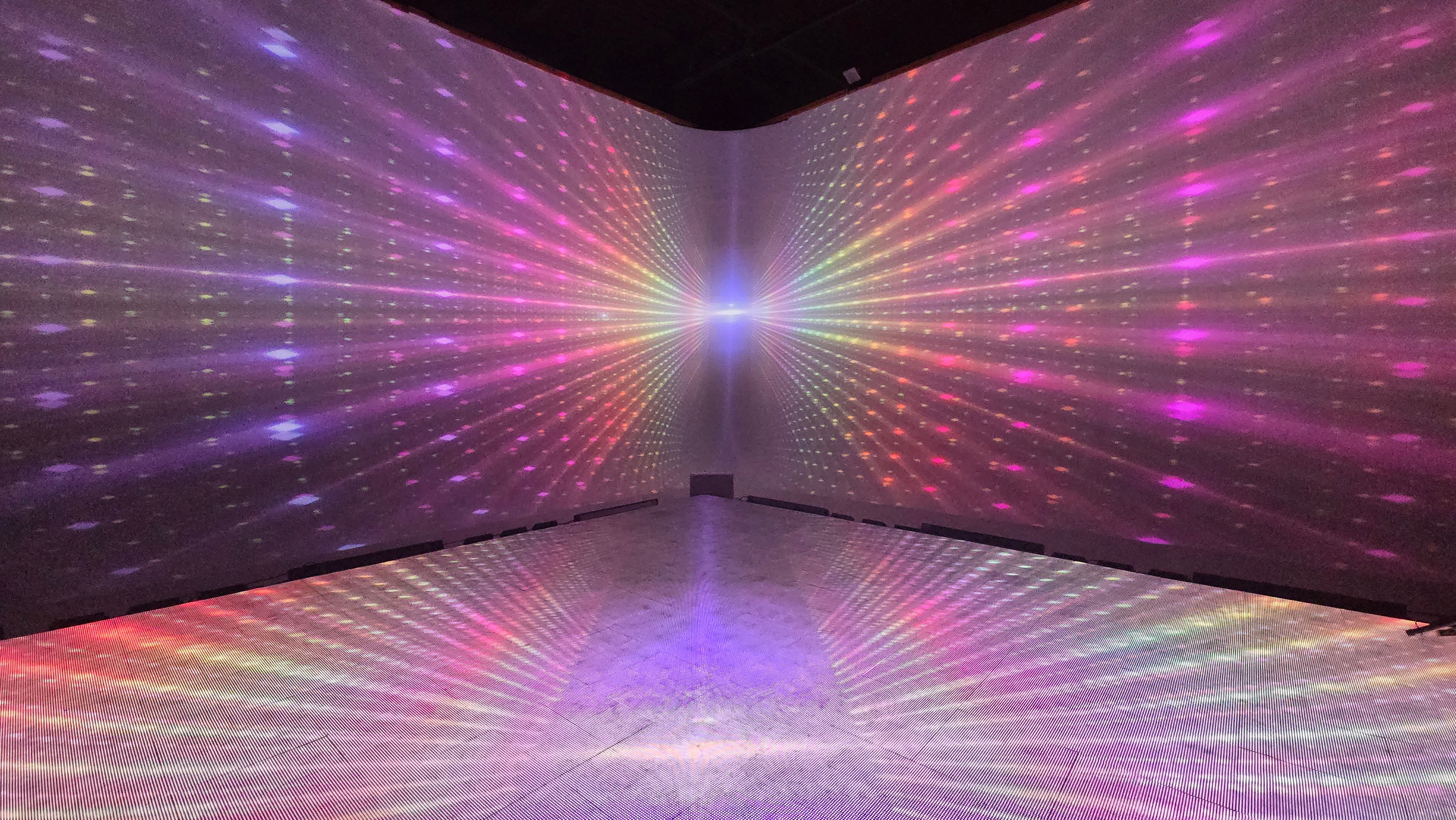 Rainbow radial light burst projection covering walls and floor