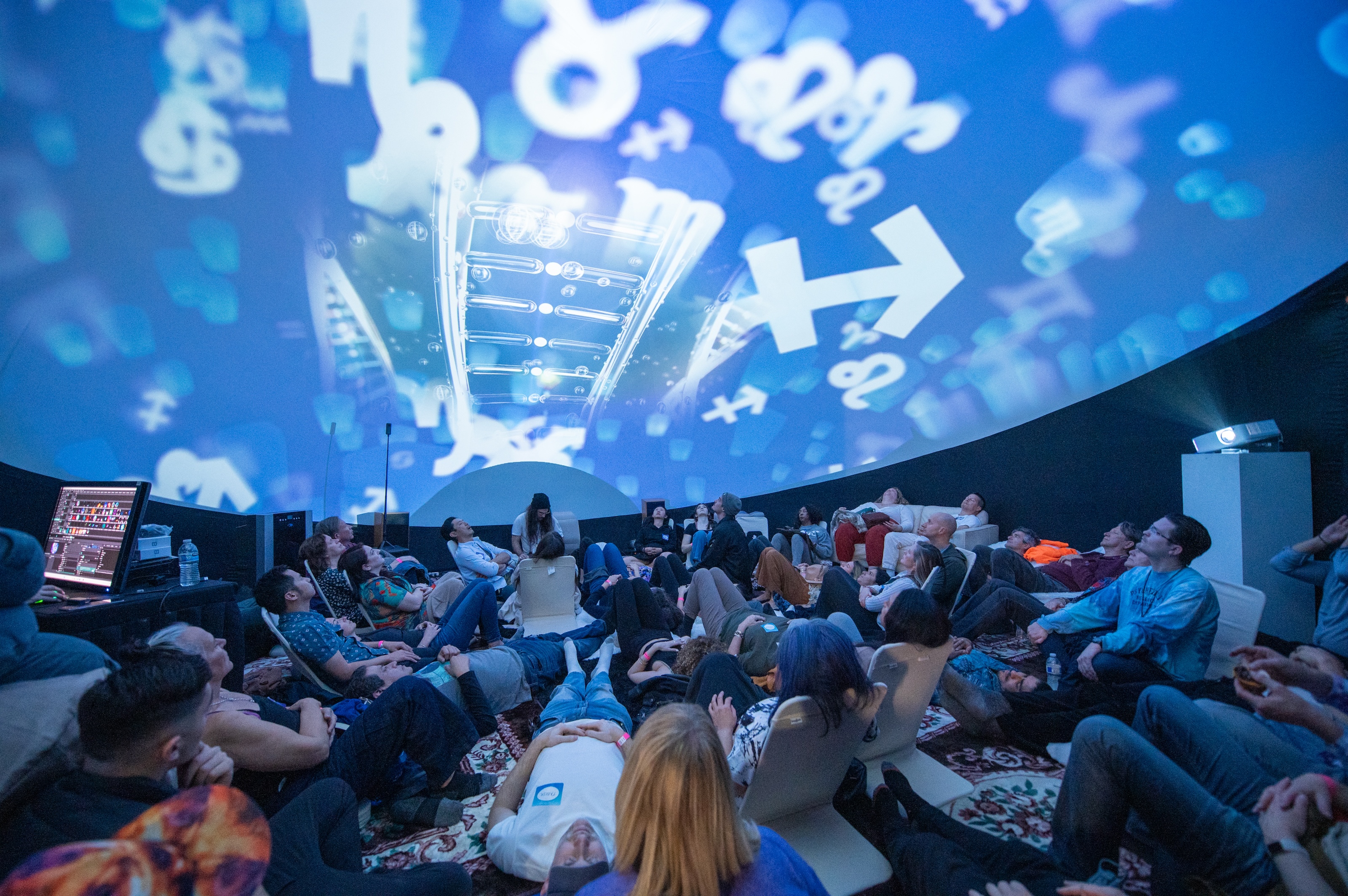 Blue symbol projections on the dome with VJ station visible